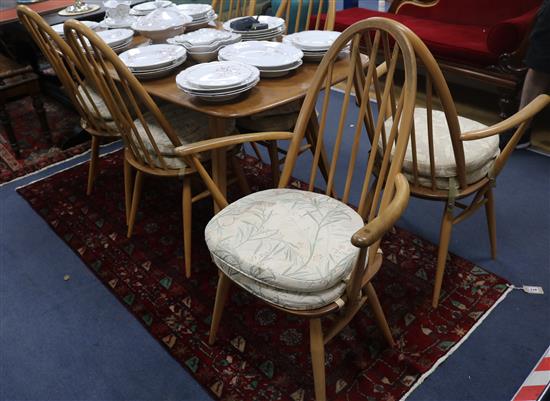 An Ercol light elm dining table and six spindle back dining chairs (4+2), 153cm wide